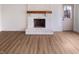 Inviting living room features a whitewashed fireplace and new flooring, ready for personalization at 9318 Drawbridge Ct, Indianapolis, IN 46250