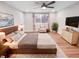Serene main bedroom with a ceiling fan, neutral tones, and a large window for natural light at 9318 Drawbridge Ct, Indianapolis, IN 46250