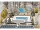 Overhead view of a community pool, tennis court, basketball court, parking lot, and clubhouse in a residential area at 10120 Youngwood Ln, Fishers, IN 46038