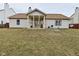 Back exterior view featuring a screened in porch overlooking the spacious backyard at 10120 Youngwood Ln, Fishers, IN 46038