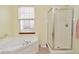 Bright bathroom features a large soaking tub next to a glass-enclosed shower at 10120 Youngwood Ln, Fishers, IN 46038