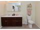 Bathroom featuring double sinks with plenty of storage and a toilet with decorated shelving at 10120 Youngwood Ln, Fishers, IN 46038