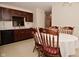 Kitchen area with dark cabinets and a table with four chairs for dining at 10120 Youngwood Ln, Fishers, IN 46038