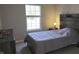 Cozy bedroom with a large window, a wooden headboard, neutral paint, and carpet, offering a comfortable retreat at 10645 Aspen Dr, Fishers, IN 46037
