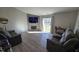Comfortable living room with a fireplace, large TV, and sliding glass door to backyard at 10645 Aspen Dr, Fishers, IN 46037