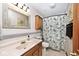 Functional bathroom with a decorative shower curtain and a classic wood vanity, providing a refreshing space at 10651 E County Road 600 N, Indianapolis, IN 46234