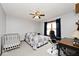 Bedroom featuring a crib and work desk, providing a cozy and functional space for Gathering and work at 10651 E County Road 600 N, Indianapolis, IN 46234