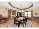 Elegant dining room featuring tray ceilings, hardwood floors, and ample seating at 10651 E County Road 600 N, Indianapolis, IN 46234