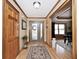 Welcoming foyer features hardwood floors, decorative rug, and a stylish front door at 10651 E County Road 600 N, Indianapolis, IN 46234