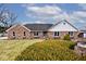 Charming brick ranch home with blue shutters, landscaped yard and inviting curb appeal at 10651 E County Road 600 N, Indianapolis, IN 46234