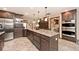 Well-equipped kitchen with a central island, stainless steel appliances, and custom cabinetry at 10651 E County Road 600 N, Indianapolis, IN 46234