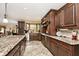 Beautiful kitchen boasts granite countertops, dark wood cabinets, and modern appliances at 10651 E County Road 600 N, Indianapolis, IN 46234