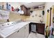 Functional laundry room with washer, dryer, utility sink, and storage shelves at 10651 E County Road 600 N, Indianapolis, IN 46234