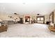 Expansive living room with plush carpeting, ceiling fans, and abundant natural light at 10651 E County Road 600 N, Indianapolis, IN 46234