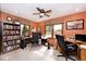 Inviting home office with built-in shelving, dual workspaces, and a ceiling fan for added comfort at 10651 E County Road 600 N, Indianapolis, IN 46234