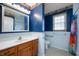 Traditional bathroom featuring blue walls, a white vanity, and framed mirror at 1114 Northfield Ln, Anderson, IN 46011