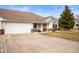 Charming front exterior featuring a two-car garage, front porch, and well-maintained landscaping at 1114 Northfield Ln, Anderson, IN 46011