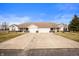 Wide view of the home exterior highlighting the attached garages and symmetrical design at 1114 Northfield Ln, Anderson, IN 46011
