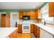 Cozy kitchen featuring wood cabinets and white appliances at 1114 Northfield Ln, Anderson, IN 46011