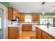 Well-lit kitchen with wooden cabinets, white counter tops, and stainless steel appliances at 1114 Northfield Ln, Anderson, IN 46011