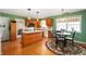 Eat-in kitchen area with white appliances, light countertops and wood cabinets at 1114 Northfield Ln, Anderson, IN 46011