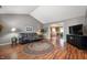 Open-concept living room with hardwood floors and view into the kitchen with island at 1114 Northfield Ln, Anderson, IN 46011