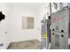 Neat utility room with appliances, a water heater, and a tile floor at 11808 Vale St, Indianapolis, IN 46235