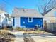Back exterior view of blue house with a white door, and a small yard at 1206 Dawson St, Indianapolis, IN 46203