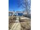 Exterior backyard with a view of the blue home, featuring a small patch of grass and concrete at 1206 Dawson St, Indianapolis, IN 46203