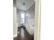 Bright bathroom with a sleek, freestanding tub, subway tile, dark wood floor, and modern fixtures at 1206 Dawson St, Indianapolis, IN 46203