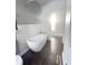 Modern bathroom featuring a freestanding tub with subway tile backsplash and dark wood-look floors at 1206 Dawson St, Indianapolis, IN 46203