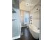 Bathroom featuring a freestanding tub, toilet, chrome fixtures, and dark wood-look flooring at 1206 Dawson St, Indianapolis, IN 46203