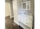 Bathroom vanity featuring white cabinets, marble-look countertop, chrome hardware, and dark floors at 1206 Dawson St, Indianapolis, IN 46203