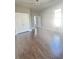 Large bedroom featuring hardwood floors, gray walls, white trim, and a double door closet at 1206 Dawson St, Indianapolis, IN 46203