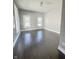 Bright bedroom with gleaming dark floors, neutral paint, and plenty of natural light at 1206 Dawson St, Indianapolis, IN 46203