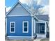 Detailed view of a blue two-story home featuring gray accents, a small porch, and a tidy walkway at 1206 Dawson St, Indianapolis, IN 46203