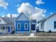 Charming blue home with white trim, sidewalk, and a well-maintained front yard under a beautiful sky at 1206 Dawson St, Indianapolis, IN 46203