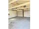 Spacious two car garage with white walls, exposed beams, and two doors at 1206 Dawson St, Indianapolis, IN 46203