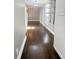 Hallway with dark hardwood floors, grey walls, storage shelving, and modern chandelier at 1206 Dawson St, Indianapolis, IN 46203