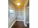 Bright laundry room with storage shelves, a window, and a dark wood floor at 1206 Dawson St, Indianapolis, IN 46203