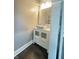 Powder room featuring stylish sink, vanity with storage, decorative light fixture, and neutral wall color at 1206 Dawson St, Indianapolis, IN 46203
