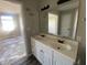 Bathroom featuring a double sink vanity with white cabinets and a large mirror at 12151 Bearsdale Dr, Indianapolis, IN 46235