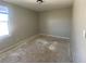 Empty bedroom showcases a bright window and bare floors ready for customization at 12151 Bearsdale Dr, Indianapolis, IN 46235