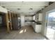 Kitchen with stainless steel appliances and white cabinets, ready for renovation at 12151 Bearsdale Dr, Indianapolis, IN 46235