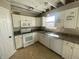 Well-lit kitchen features updated appliances and white cabinetry, ready for renovation at 12151 Bearsdale Dr, Indianapolis, IN 46235