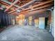 This basement features unfinished walls, concrete flooring, exposed utilities and a black wall at 1239 Brooks St, Indianapolis, IN 46202