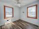 This bedroom features hardwood flooring, two windows, white ceilings and white walls at 1239 Brooks St, Indianapolis, IN 46202