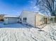 Side view of house and detached garage with snow covered yard at 1239 Brooks St, Indianapolis, IN 46202
