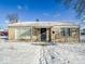 Charming brick single-story home with covered porch and snow-covered front yard at 1239 Brooks St, Indianapolis, IN 46202