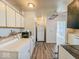 The kitchen and laundry area feature tile backsplash, wood cabinets, and modern appliances at 1239 Brooks St, Indianapolis, IN 46202